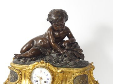 Grande pendule de style Louis XVI en bronze doré et patiné à décor d'a