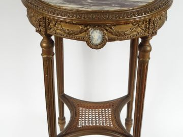 Guéridon de style Louis Xvi en bois sculpté et doré, orné de plaques d