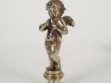 Cachet XIX en bronze argenté en forme d'amour. H. 8 cm