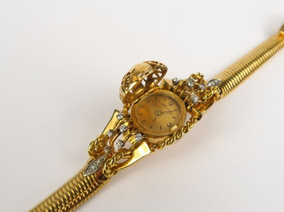MERCURY. Montre de dame en or, bracelet turbogaz, cadran dôme ajouré o