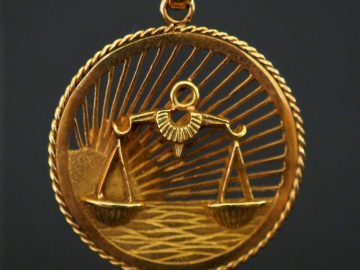 Pendentif en or ajouré, allégorie du signe de la balance. Diam. 3,5 cm