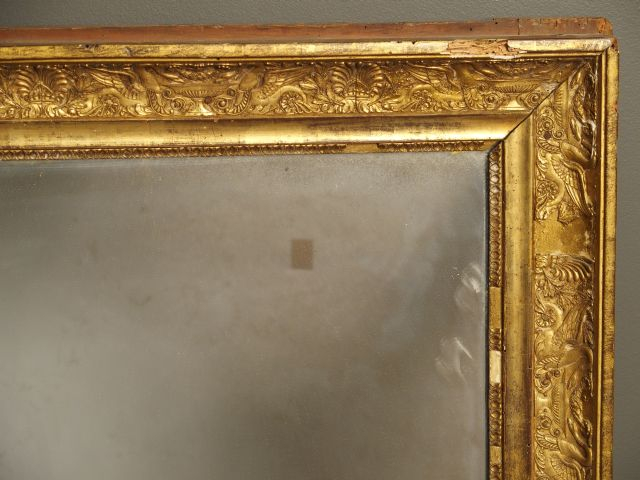 Glace de cheminée de style Empire en bois et stuc doré, à décor d'anim