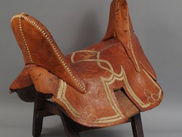 Selle de cavalerie en cuir rouge à décor brodé en coton blanc (entrela