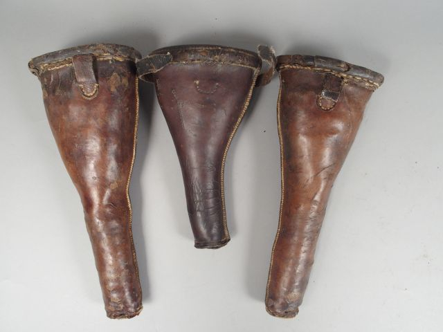 Lot de trois fontes de pistolet en cuir fauve, états divers. (2)