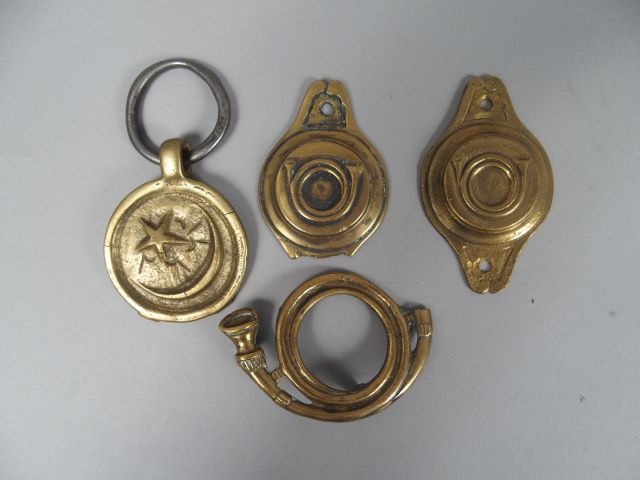 Lot de cuivreries militaire dont deux mascarons de mors en bronze au c