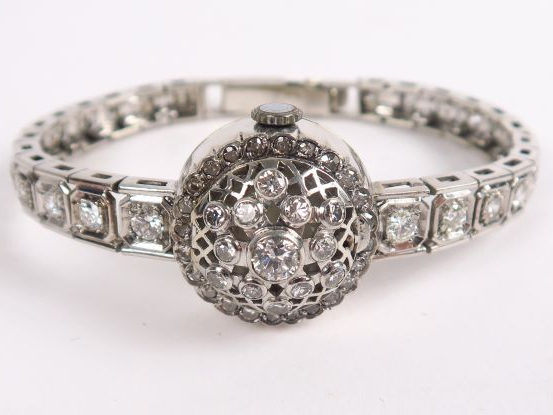 GERALDY. Montre bracelet à  en or blanc et platine, bracelet et couver