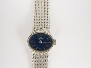 CC-Montre de dame Oméga or blanc, cadran entouré de 10 brillants taill