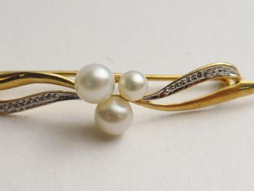 Broche en or ornée de 3 perles. Poids tel : 2,69 g