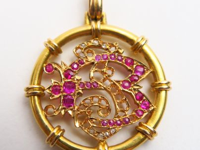 Pendentif en or jaune serti de pierres roses et blanches. Poids tel : 