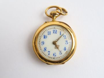 Montre de col en or, partie en métal. Poids tel : 14,6 g