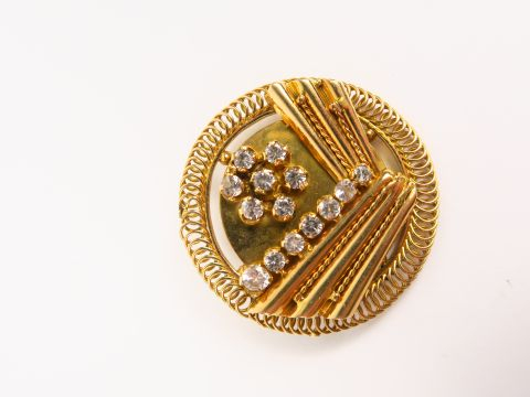 Broche de style Art déco en or et pierres à l'imitation du diamant.  1