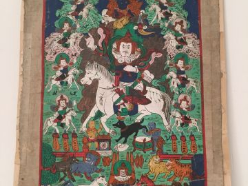 Petit thangka représentant le roi Gésar sur son cheval, entouré de div