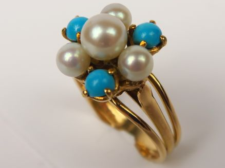 Bague en or jaune figurant une fleur, sertie de turquoises et petites 