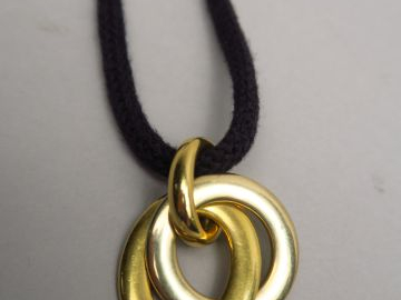 POMELATTO. Pendentif en or, trois anneaux. Signé. Poids : 29,5 g. Avec