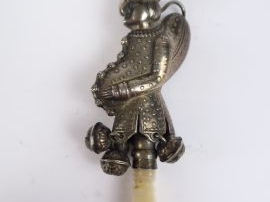 Hochet siffleur XIXe en argent, figurant polichinelle. Retenant quatre