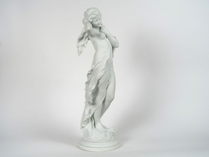 A. MOREAU. "Jeune fille nue à l'oiseau". Sculpture en biscuit. Signée.