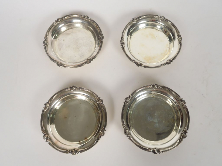 CHRISTOFLE.  Quatre dessous de bouteille de style Louis XV en métal ar