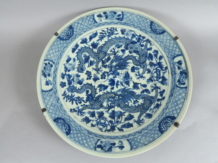 Plat en porcelaine bleu blanc, à décor de deux dragons parmi des fleur