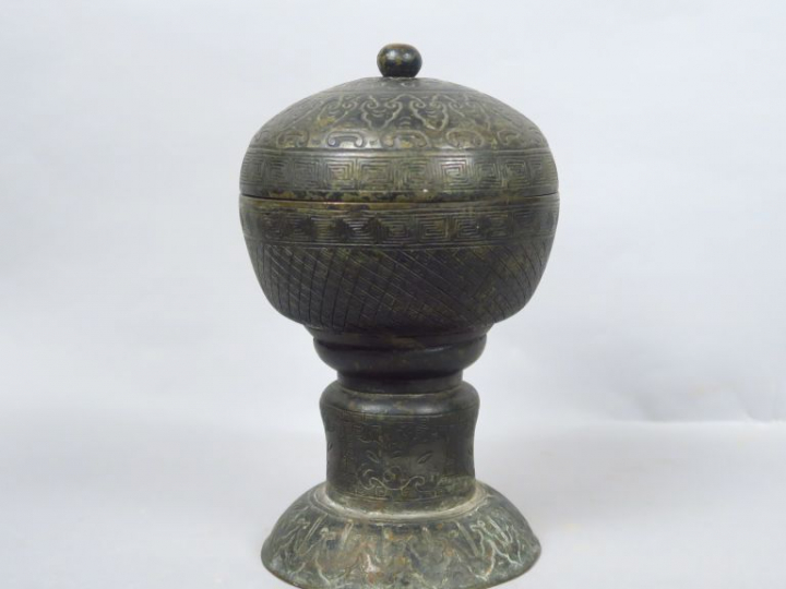 Coupe couverte sur piédouche, en étain de patine verte, à décor de mot