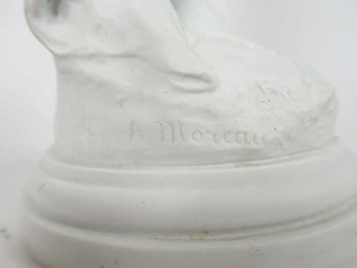 A. MOREAU. "Jeune fille nue à l'oiseau". Sculpture en biscuit. Signée.