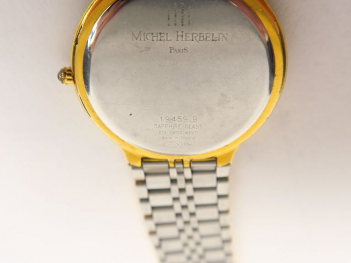 Michel HERBELIN  Montre de dame en métal et métal doré.