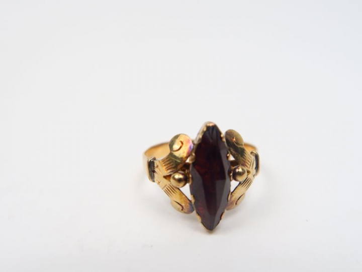 Trois différentes bagues dont : - Bague en or, ornée d'un grenat Poids