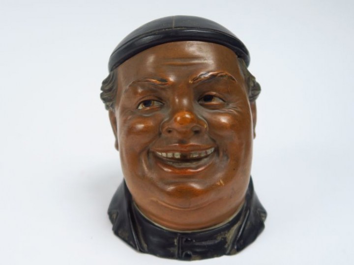 Pot à tabac fin XIXème en stuc polychrome en forme de curé riant.  H. 