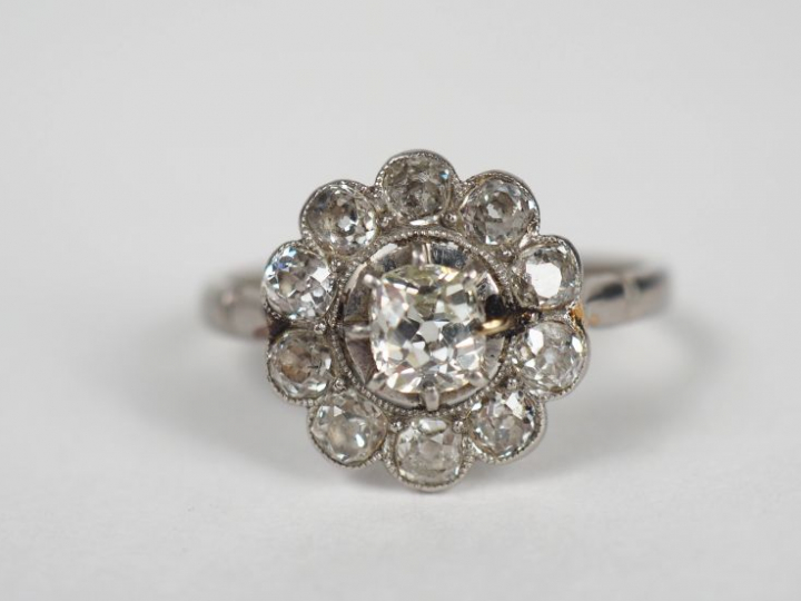 Bague marguerite en or blanc, ornée en son centre d'un diamant entouré