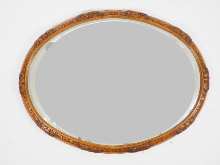 Léon JALLOT. Grand miroir ovale cadre en bois sculpté à décor de fleur