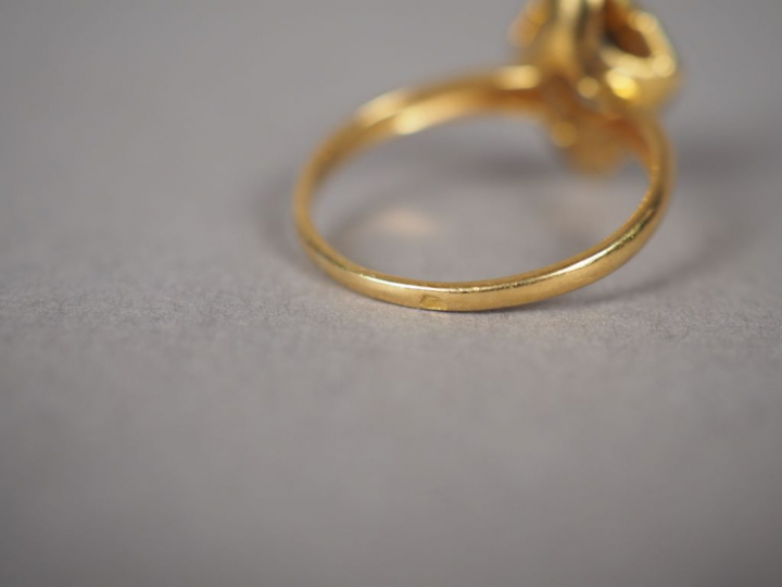 Bague en or jaune en forme de fleur, ornée en son centre d'un saphir e