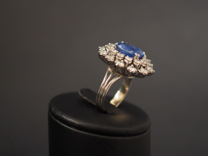 Bague en or blanc en forme de fleur, ornée en son centre d'un saphir e