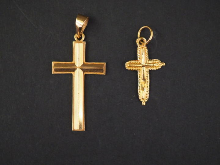 Deux différents pendentifs en or jaune en forme de croix.  2 x 1,3 cm 