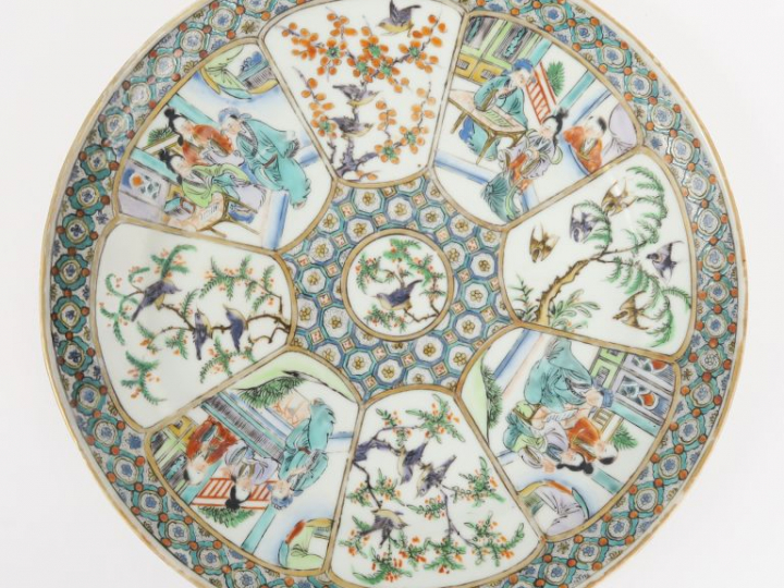Assiette en porcelaine de Canton, à décor de personnages dans des pala