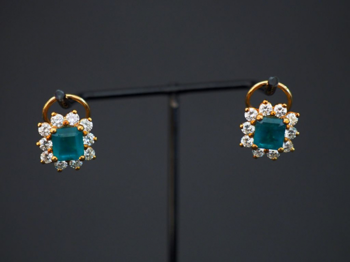 Paire de perce oreilles "marguerite", émeraude entourée de dix diamant