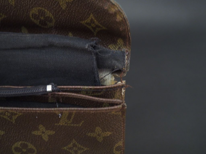 VUITTON. Pochette en toile Monogram marron  Dim.  28 x 18 cm (déchirur