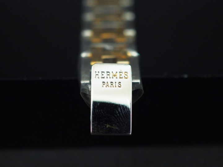 HERMES Montre bracelet de dame, modèle Rallye, en acier et métal doré.