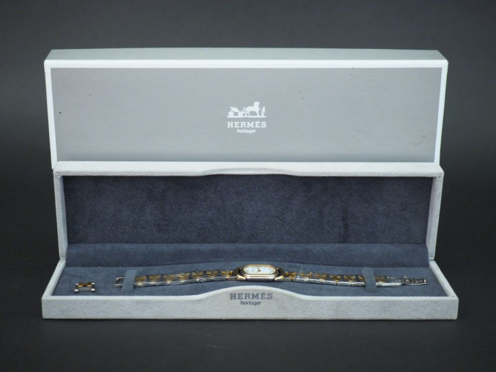 HERMES Montre bracelet de dame, modèle Rallye, en acier et métal doré.