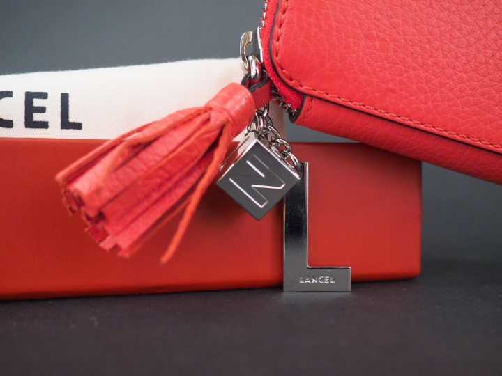 LANCEL Portefeuille en cuir rouge. Dans sa housse et sa boite d’origin