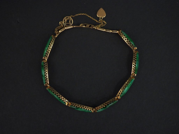 Bracelet articulé en or jaune, à décor de maillons ovales sertis de ja