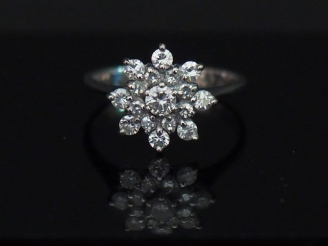 Vente aux enchères Bague marguerite en or blanc, sertie en son centre d'un diamant centra