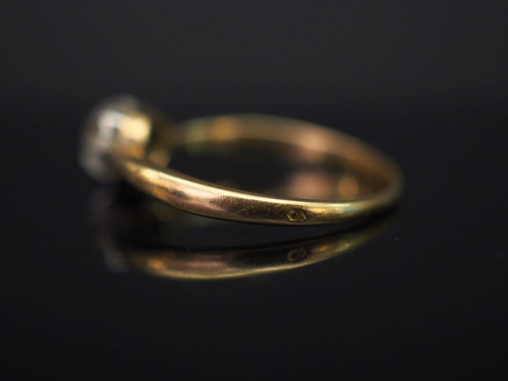 	Bague solitaire en or jaune, sertie en son centre d’un petit diamant 