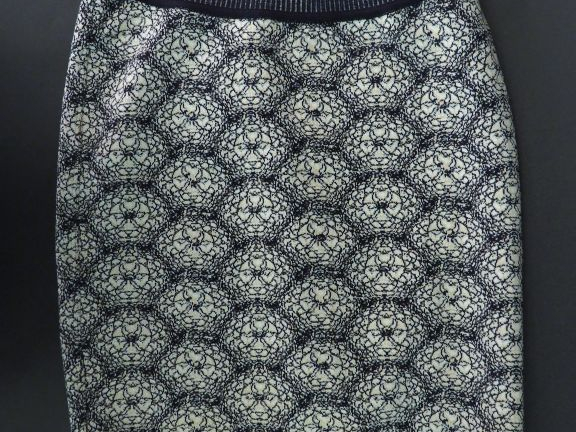 ALAÏA. Mini jupe en maille dans les tons noir et blanc, à décor de fle