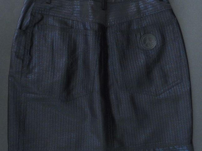 MOSCHINO.  Jupe en tissu noir brillant. Trois poches à l’avant et deux