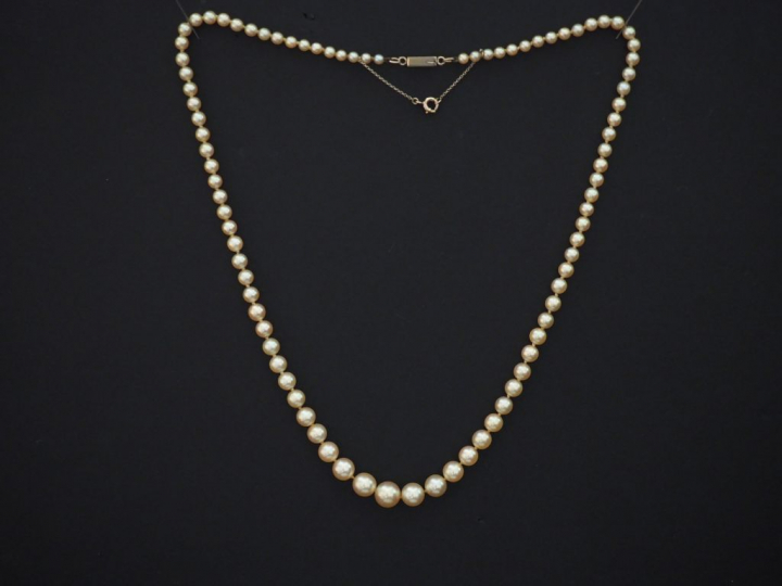 Collier de perles disposées en chute. Fermoir en or jaune. Chainette d