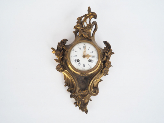 Vente aux enchères Cartel de style Louis XV en bronze, à décor de rocailles et de fleurs.