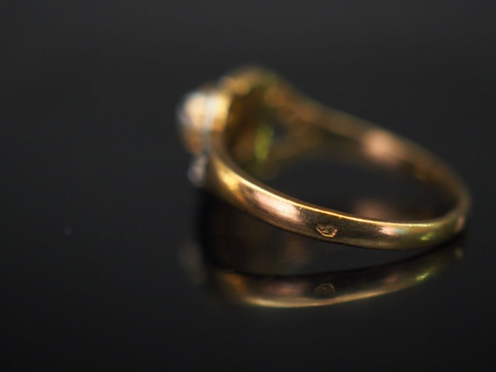 Bague en or jaune, sertie en son centre d'une perle. La monture mouvem