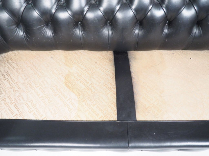 Canapé Chesterfield en cuir noir.