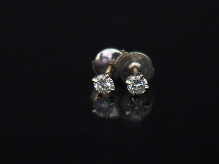 	Paire de puces d’oreilles en or blanc, serties d’un diamant.  Système