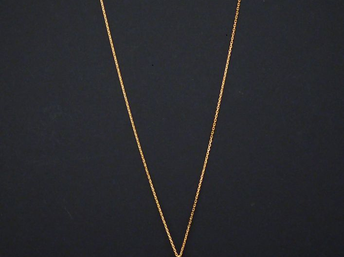 Collier en or jaune, maille forçat, à décor d'un pendentif serti de co