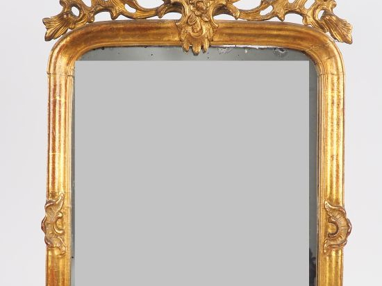 Miroir de style Régence en bois sculpté et doré, à décor de rocaille, 